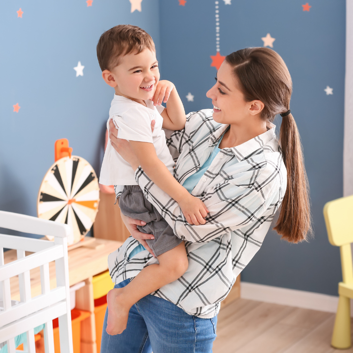 Babysitter holding child.